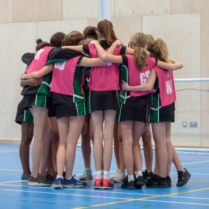 girls huddled in the netball