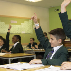 children raising hands