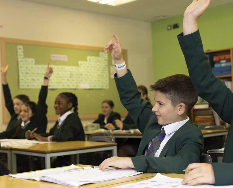 children raising hands
