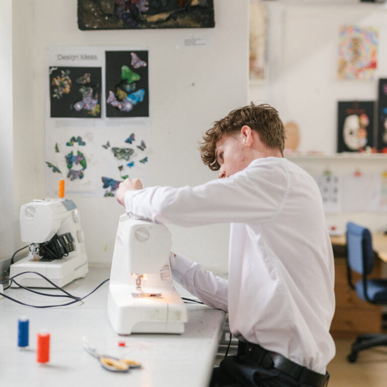 boy using sewing machine