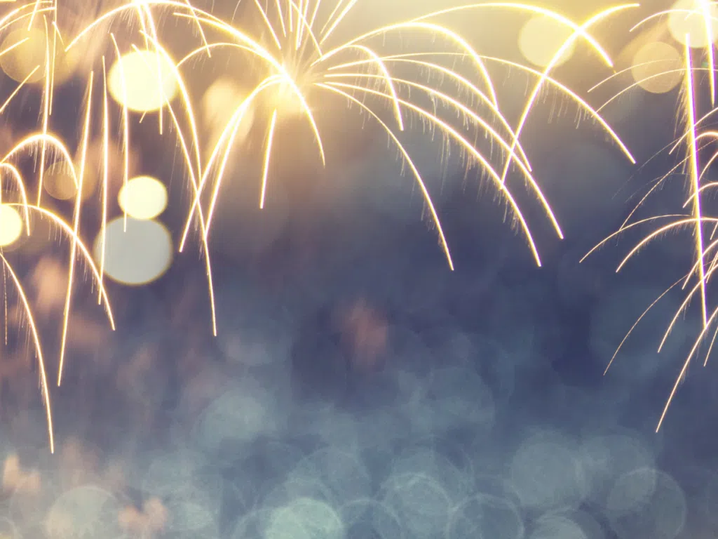 Fireworks explode with golden streaks and soft bokeh lights across a dark background; the word 'Fireworks' appears at the bottom.
